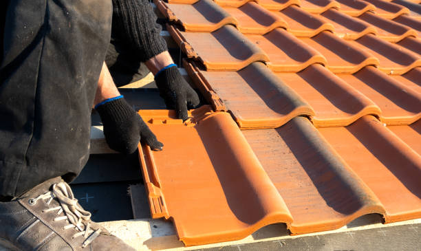Close-up of professional roofer installing tiles